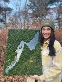 Brittney Carbone with an aerial view landscape commission of a pond in Maine